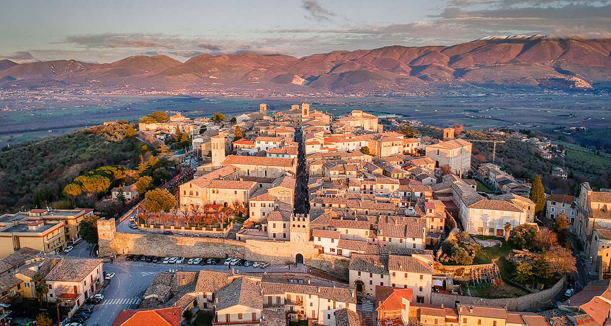 Golden hour light over a hilltop village in the Tuscany Umbria Marche border region
