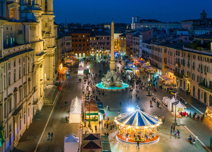 Italian Christmas market at dusk with festive lights, artisanal stalls, seasonal treats, and cultural ambiance.