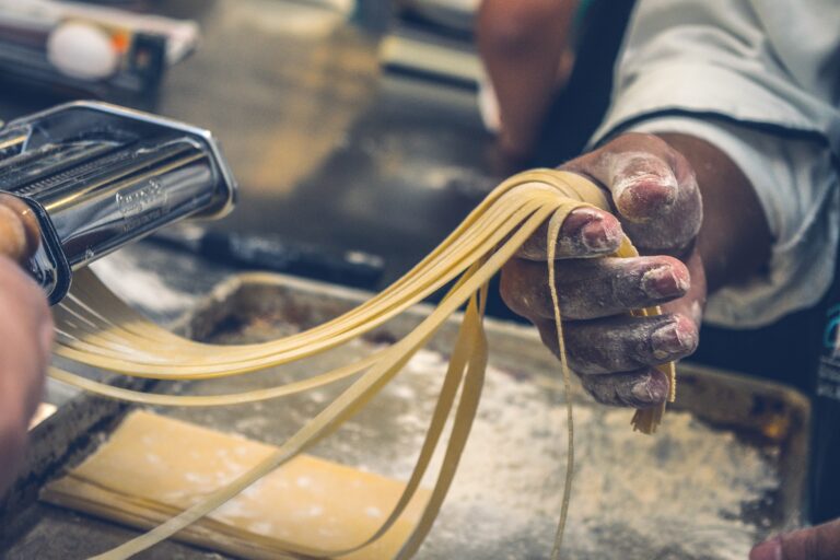 Artisan shaping fresh pasta, demonstrating traditional Italian culinary techniques