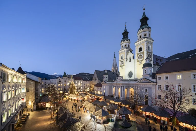 Bolzano Christmas market stalls under Alpine lights