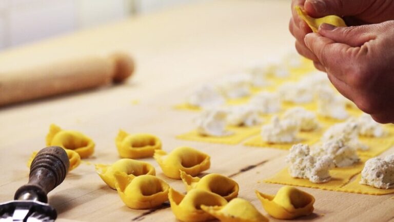 Hands shaping fresh pasta, highlighting Italian culinary craftsmanship
